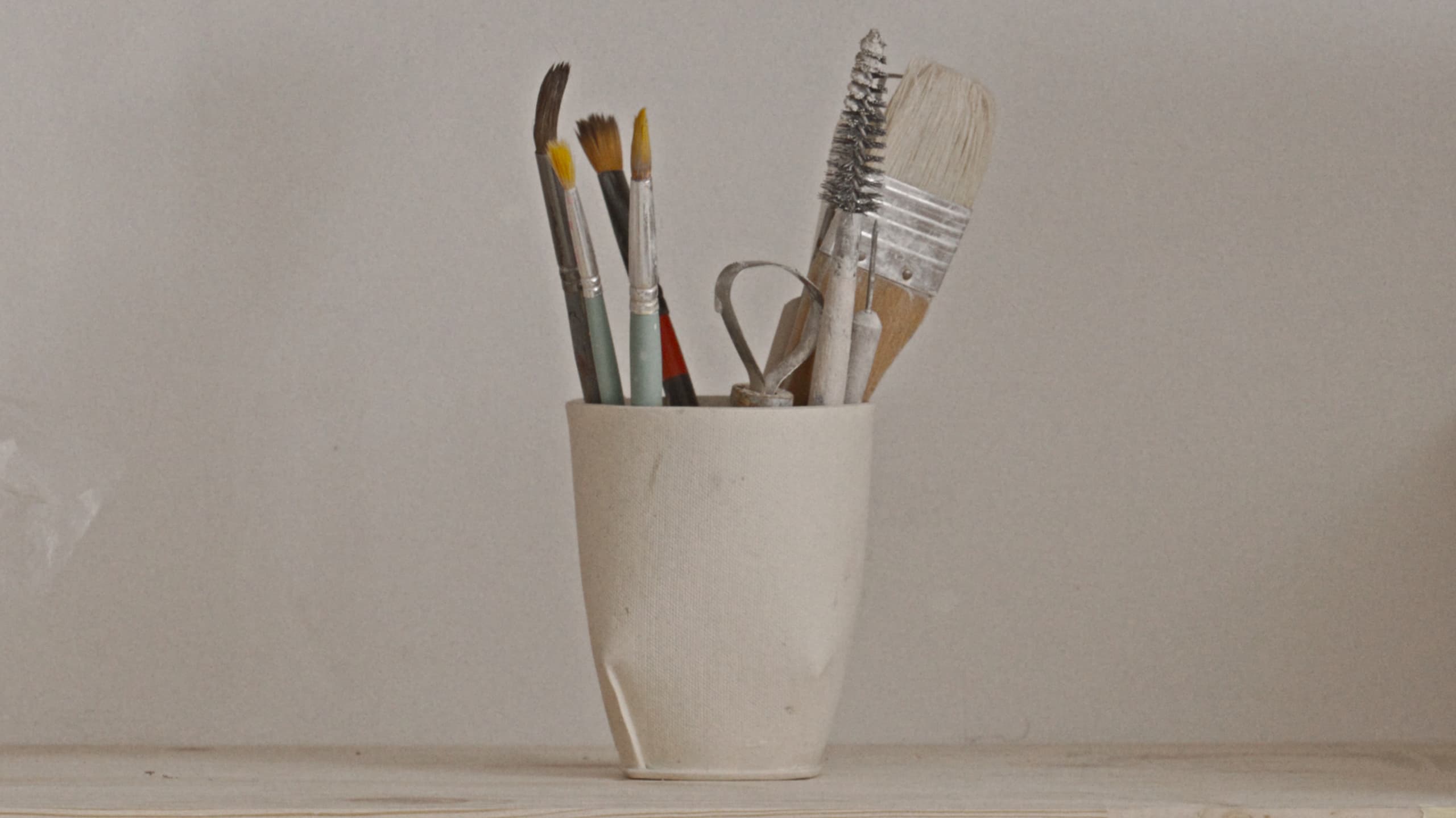 Brushes and tools in a ceramic cup