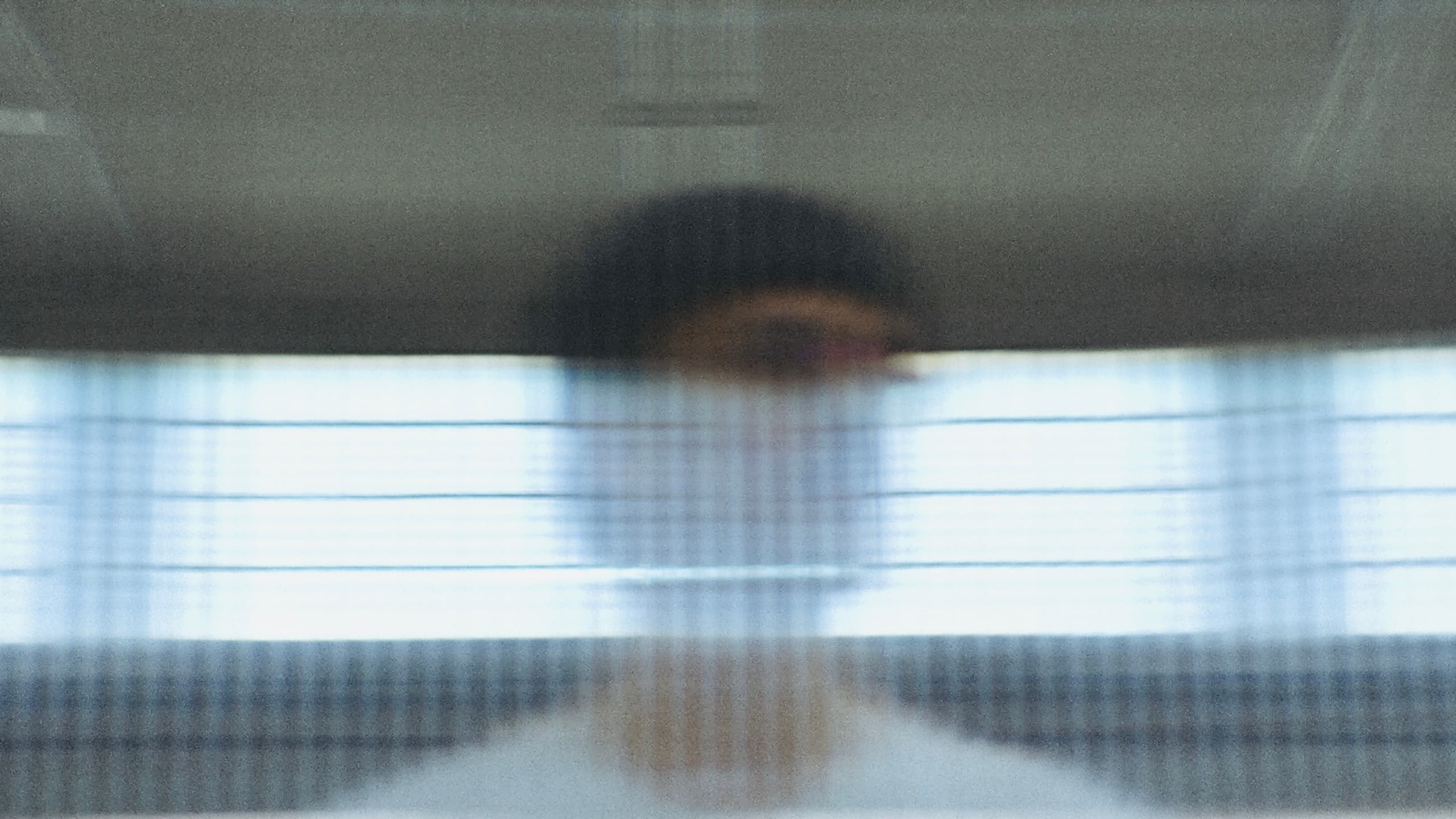 Fil Palmer blurred behind ribbed glass