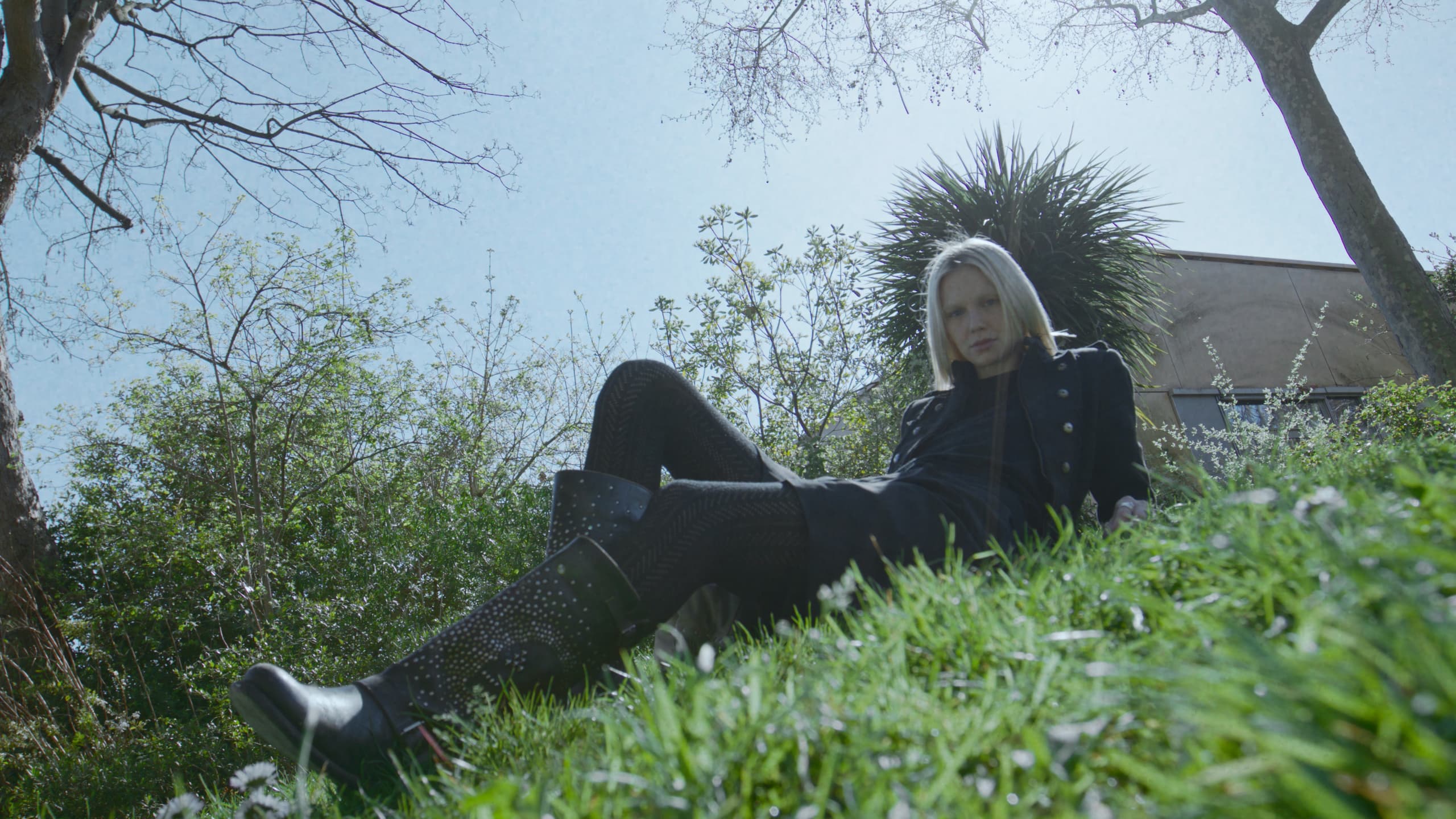 Lea Pliger lying on a grass bank in a Paris park